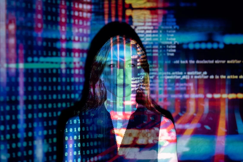 executive woman with colorful tech information projected onto her and the background